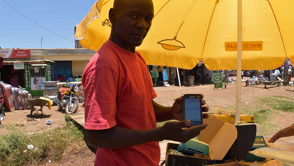 Mwezi sales agent Morris uses the Angaza Activator app to make new sales and track payments