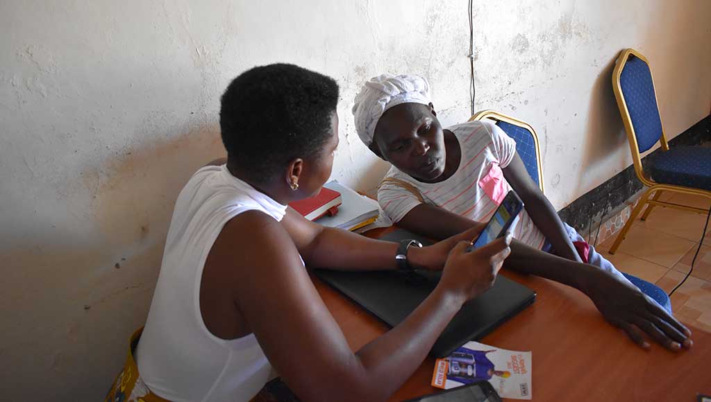 Branch Manager Rachel with a potential client in Mwezi’s pay as you go shop