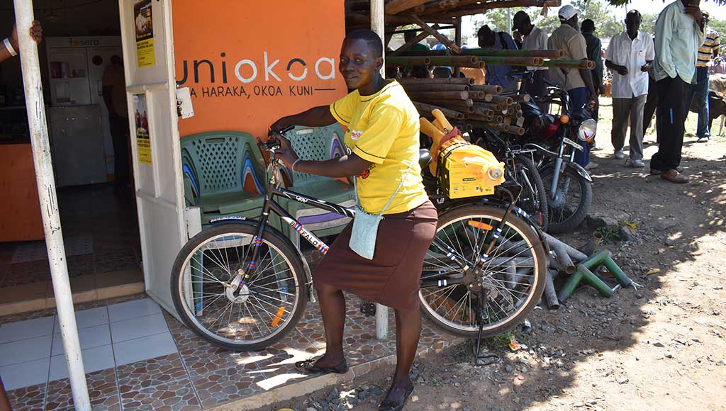 Sales agent Susanne transports products on a Mwezi-provided bicycle