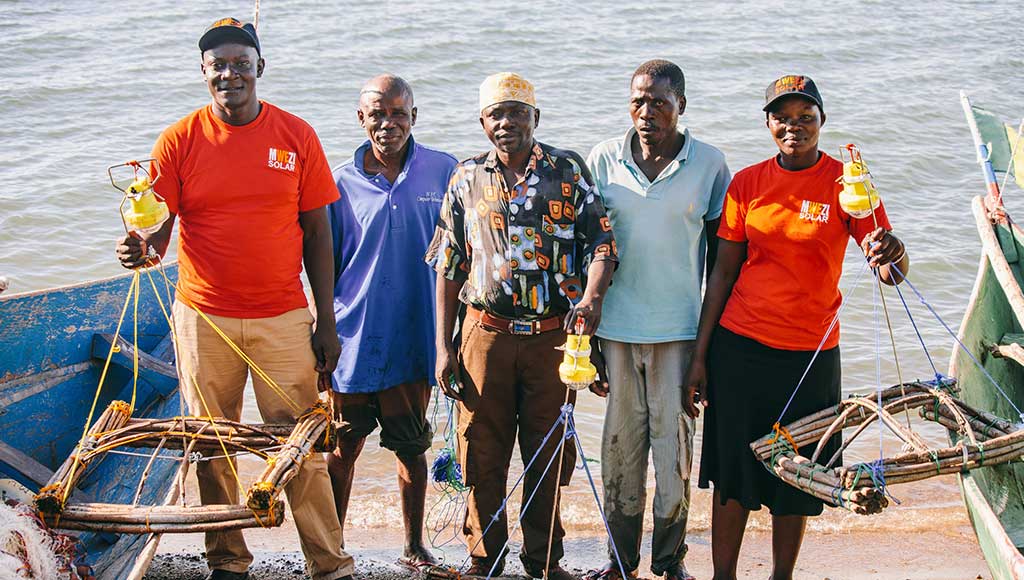 Mwezi with their clients, who use pay-as-you-go OvCatch lamps for night fishing